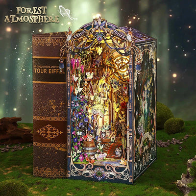 Fairytale Houses book nook beside a book, with an ornate vine-like frame and glowing forest interior.