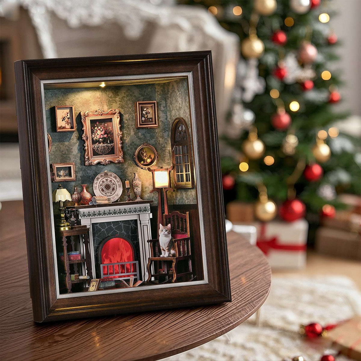 Fireplace story frame on a table beside a Christmas tree, with a miniature glowing hearth inside.