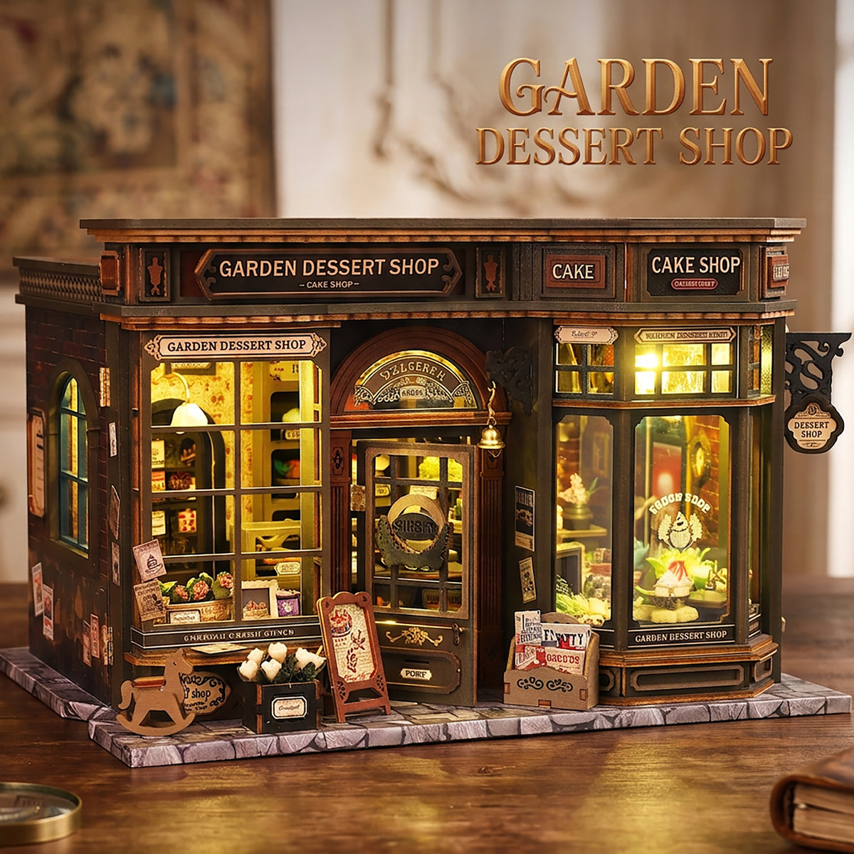 Garden Dessert Shop miniature storefront with cake displays, dark trim and warm-lit windows.