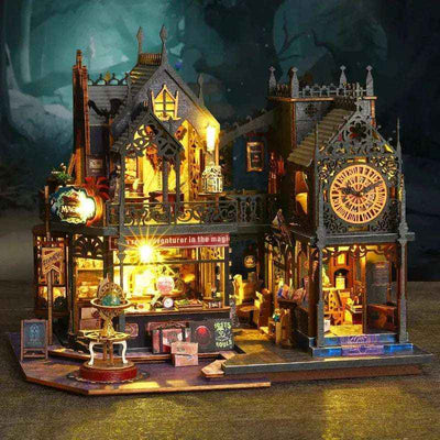Front view of Holo Magic City with glowing shop windows, dark rooftops and a miniature clock tower.