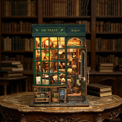 Ink Trace Bookstore green storefront book nook with warm-lit shelves and books displayed outside.