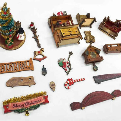 Jingle Cabin miniature components arranged separately, including a tree, bench, drawers, snowman and Santa.