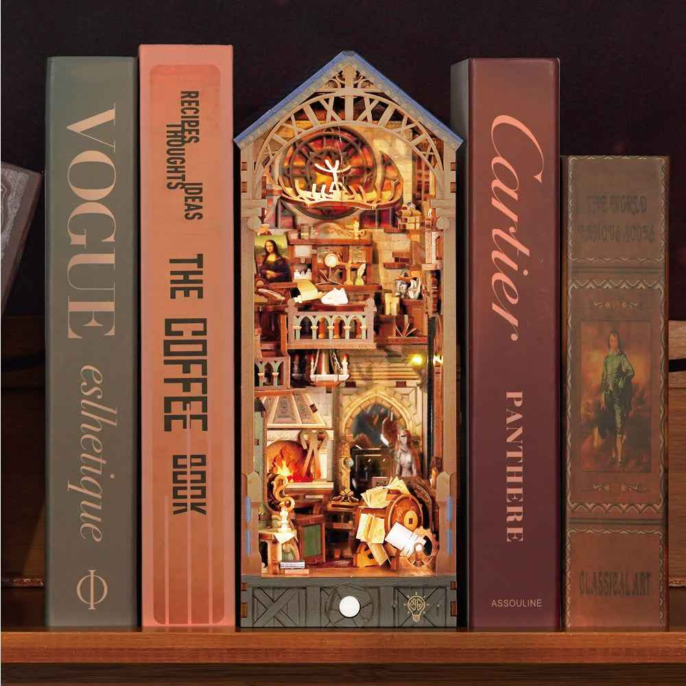 Leonardo da Vinci book nook between books with a miniature workshop beneath a pitched roof.