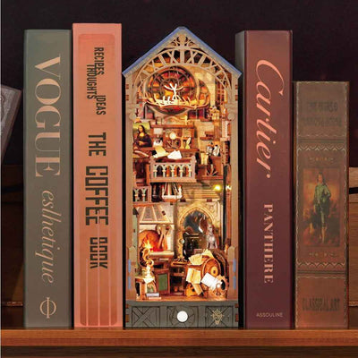 Leonardo da Vinci book nook between books with a miniature workshop beneath a pitched roof.