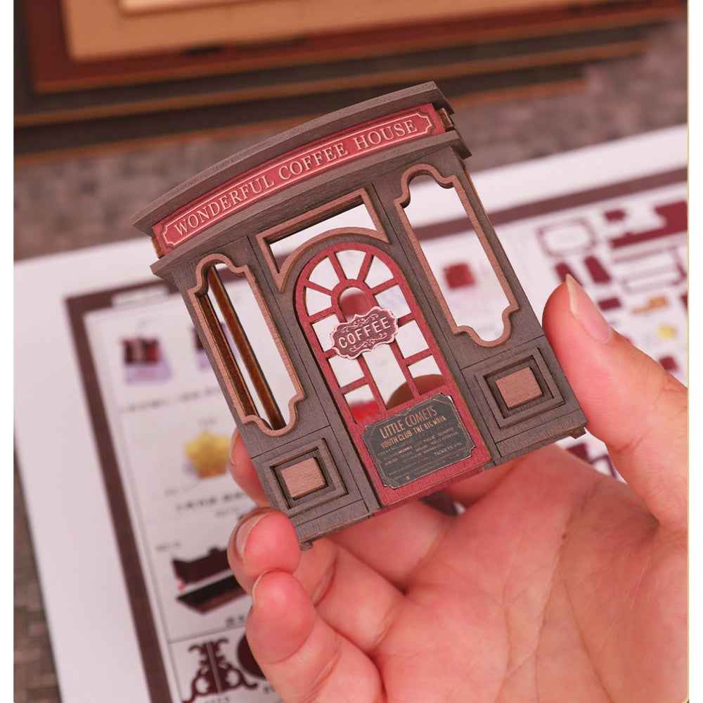 Hand holding a Letter Coffee shopfront panel over illustrated instructions.
