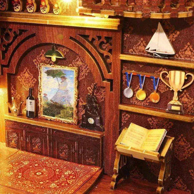 Library of Books miniature wall display with framed art, medals, a trophy and a model sailboat.