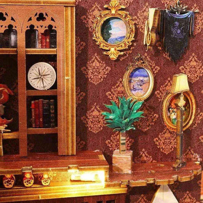 Miniature portraits, potted plant and lamp beside the Library of Books upper balcony.
