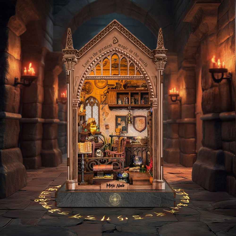 Magic Abode book nook with a pointed Gothic arch and warm-lit miniature room.