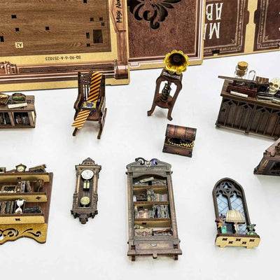 Magic Abode miniature furniture, gramophone, clock and window pieces laid out for assembly.