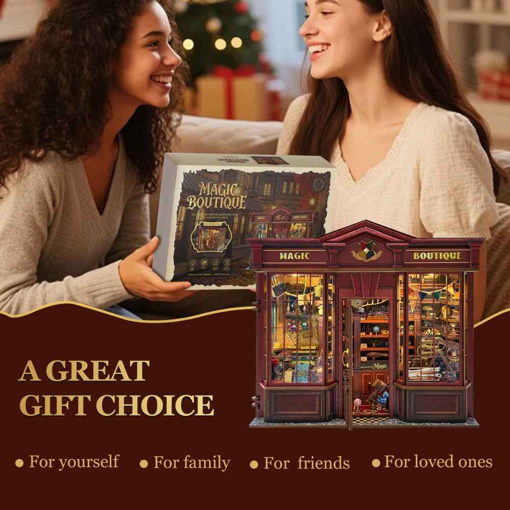 Two women holding a Magic Boutique kit box beside the assembled shop.
