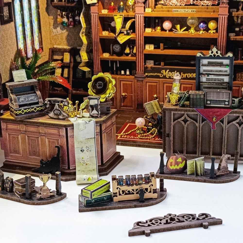 Magic Boutique miniature counters, gramophone, cauldron and shop decorations laid out separately.
