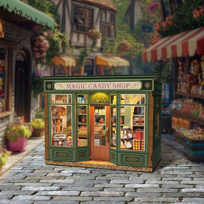 Magic Candy Shop green storefront with arched windows and miniature sweets on display.