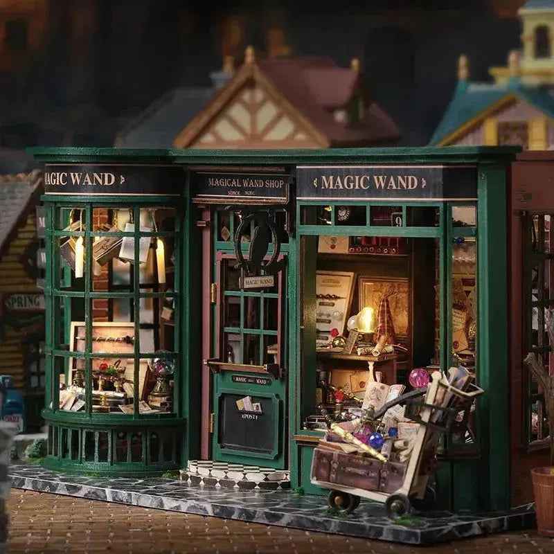 Angled Magic House book nook showing the green storefront and miniature luggage trolley.