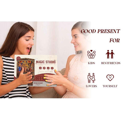 Two women holding the Magic Studio upgraded edition kit box.