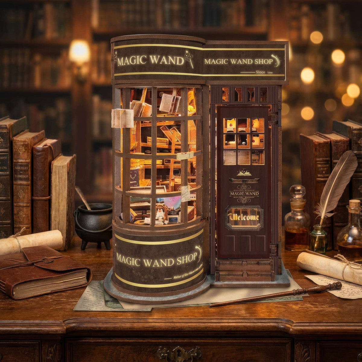 Magic Wand Store on a wooden desk beside books, a quill and an ink bottle.