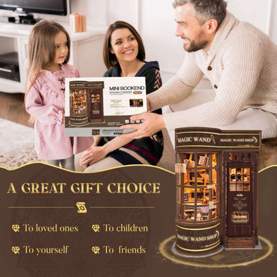 Family holding a Magic Wand Store kit box beside the assembled shop.