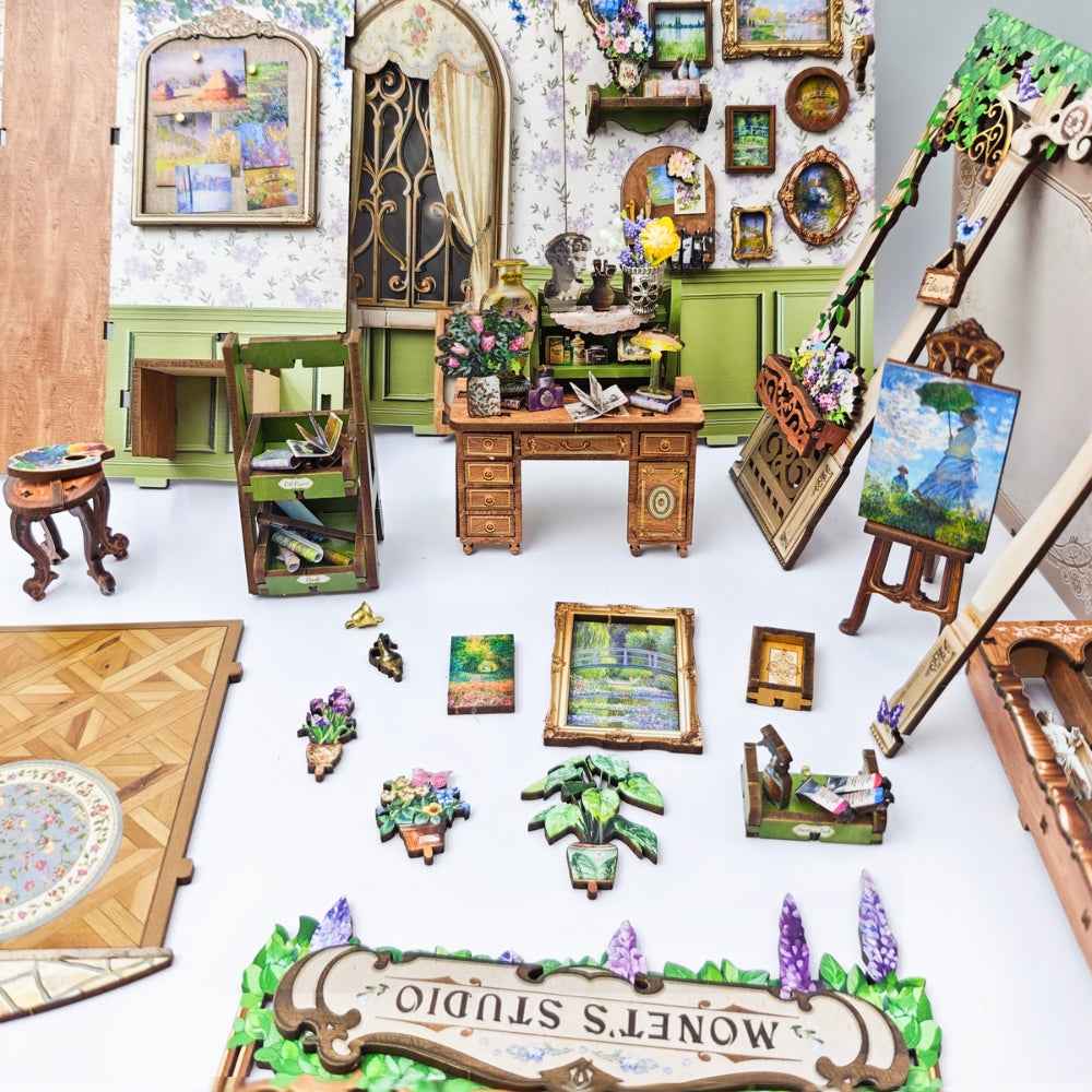 Monet's Impression miniature paintings, studio furniture and flower decorations laid out separately.