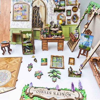 Monet's Impression miniature paintings, studio furniture and flower decorations laid out separately.