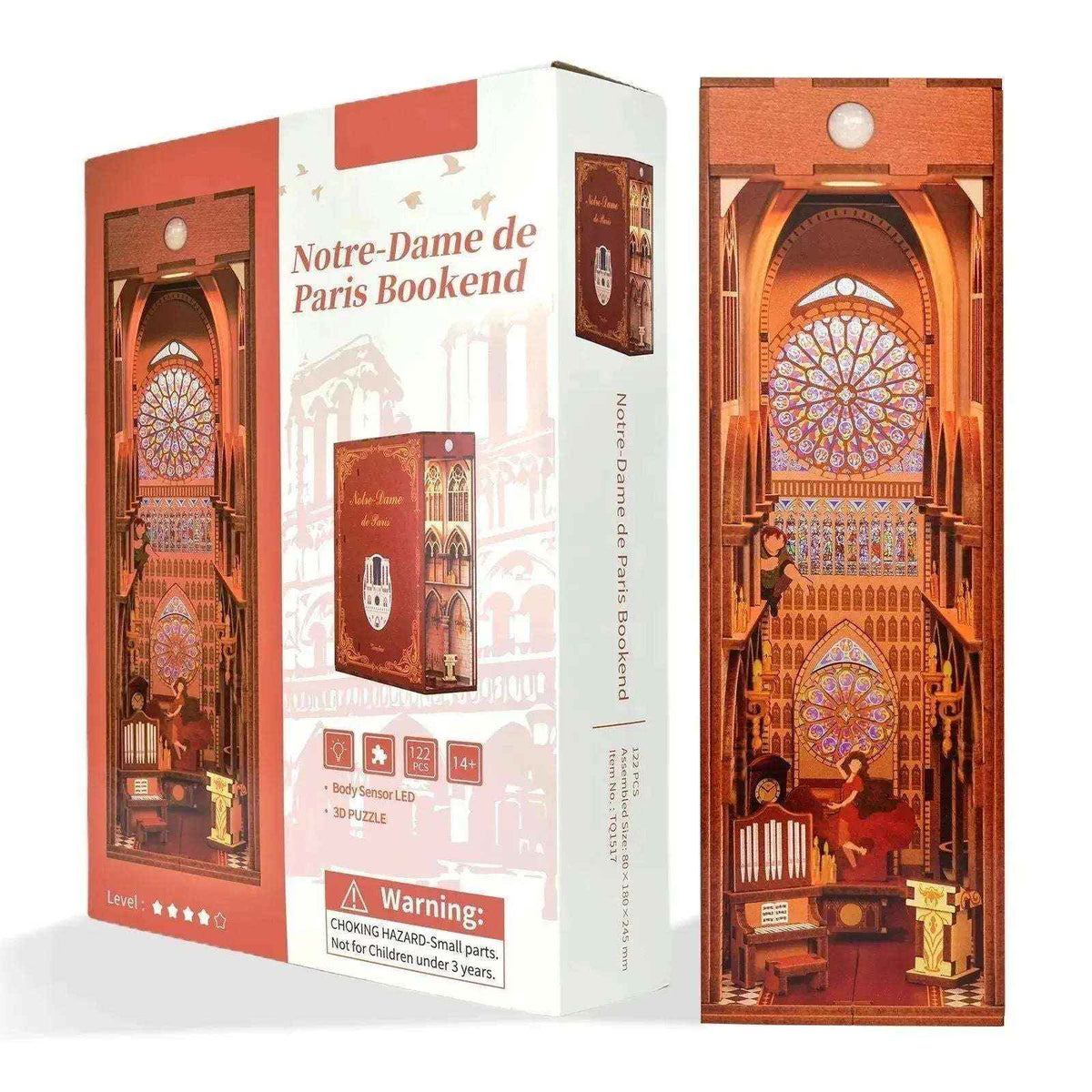 Notre-Dame de Paris cathedral book nook beside its red-and-white kit packaging.