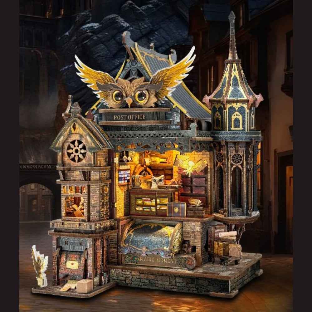 Owl Post Office miniature building with a large golden owl above the roof and tiny parcels inside.