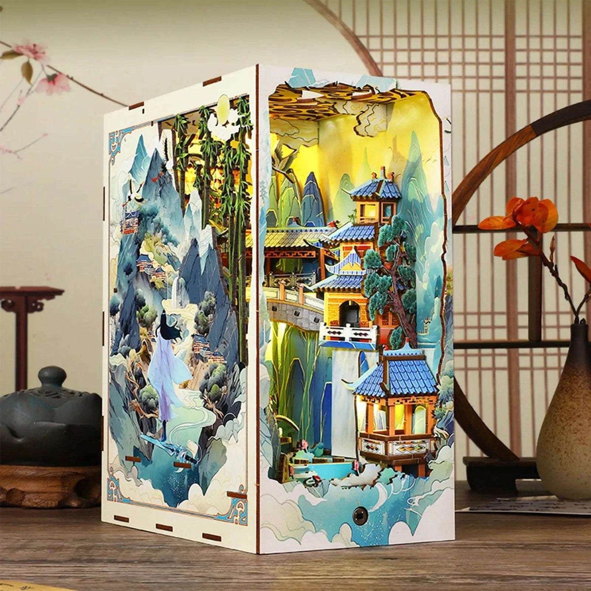 Penglai Wonderland book nook showing its illustrated mountain cover and tiered miniature pavilions.