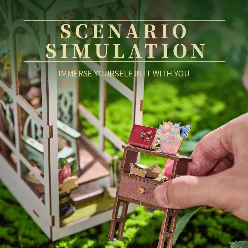 Hand placing a miniature flower stand inside the Romantic Garden book nook.