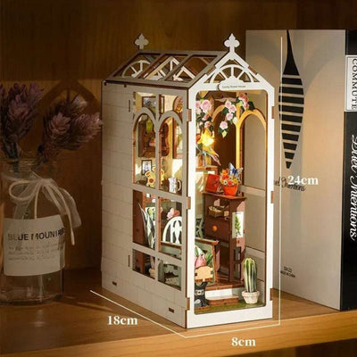 Romantic Garden greenhouse book nook dimension diagram beside a stack of books.