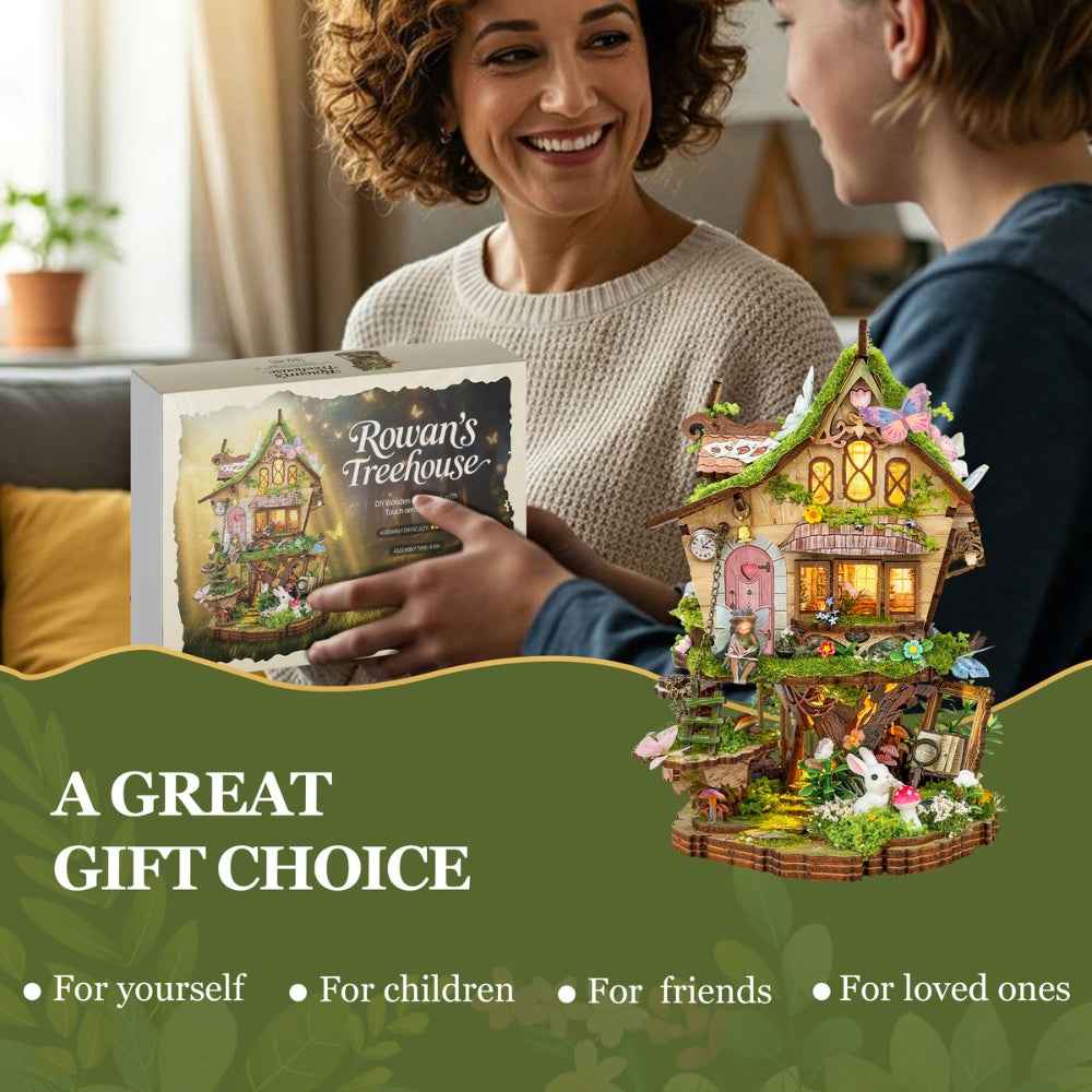 Two people exchanging a Rowan's Treehouse kit box beside the completed model.