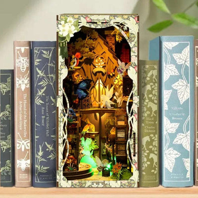 Secret World of the Forest book nook between books, with glowing miniature tree houses and foliage.
