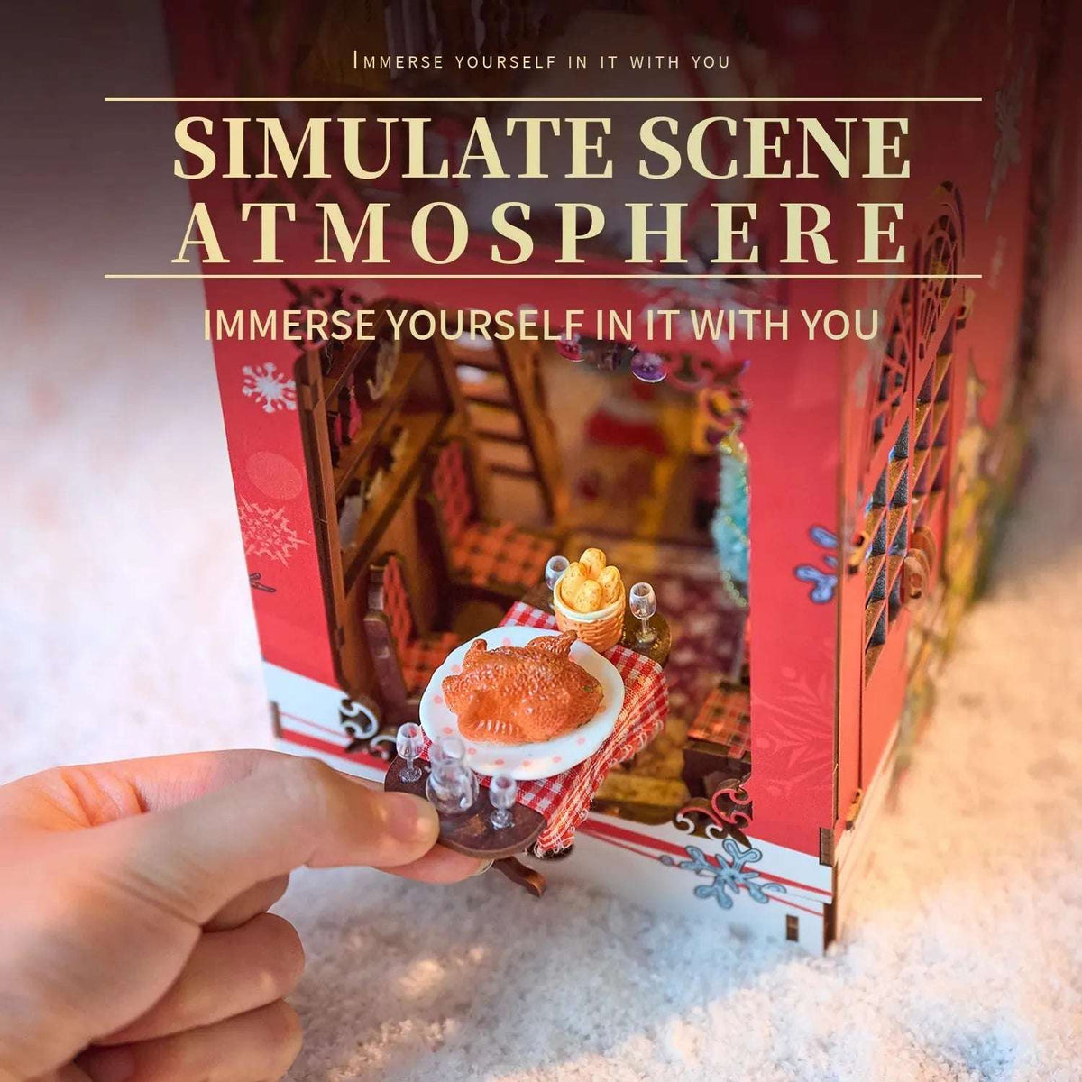 Hand placing a miniature festive dining table inside Songs of the Snowy Night.