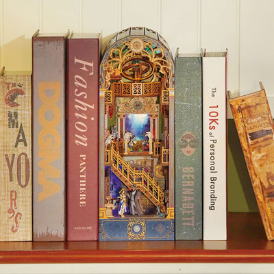 Spacetime Museum book nook between books, with an arched top and two levels of miniature exhibits.