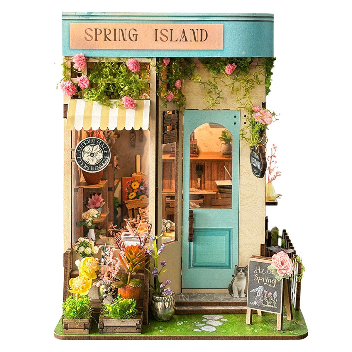 Front view of Spring Island with a striped awning, turquoise door and miniature flower display.