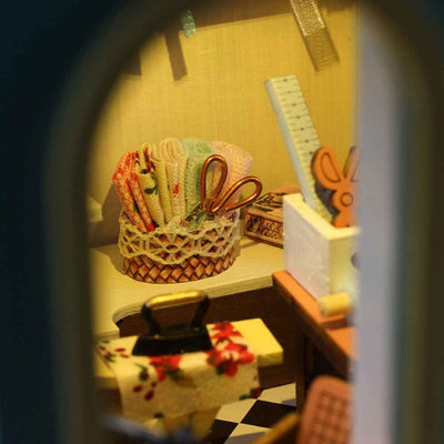 Tailor Shop close-up of miniature scissors, rulers and sewing tools in baskets.
