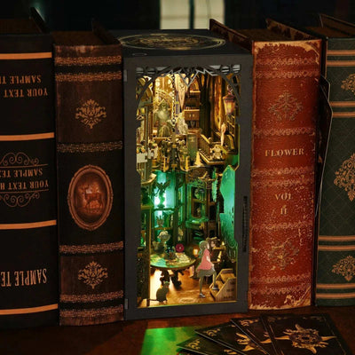 Tarot Divination Society book nook between books, showing its illuminated two-level interior.