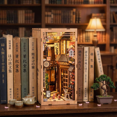 The Alley Waiting for the Cat book nook among books, showing a narrow Japanese shop-lined alley.