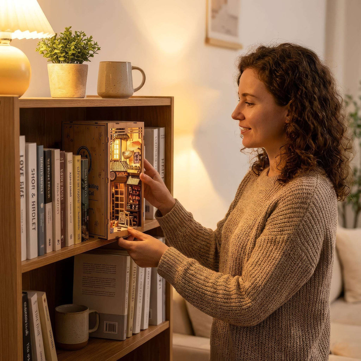 Woman placing The Alley Waiting for the Cat book nook on a bookshelf.