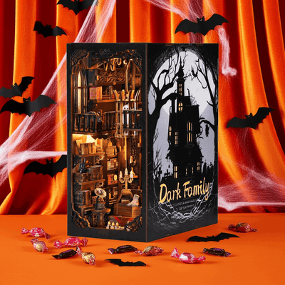 The Dark Family book nook against an orange Halloween backdrop with paper bats and cobwebs.