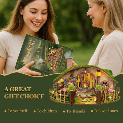 Two women holding The Magic Ring House kit box beside the completed cottage.