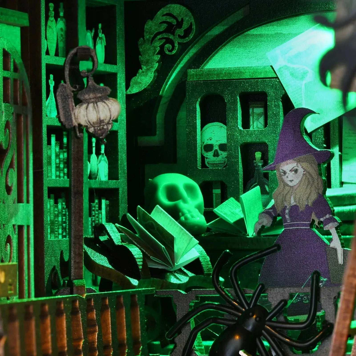 Witch figure, suspended pages and miniature skulls in the green-lit room of The Monster's House.