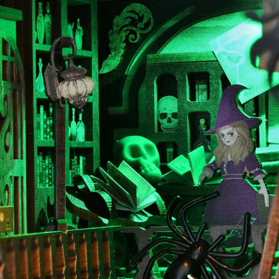 Witch figure, suspended pages and miniature skulls in the green-lit room of The Monster's House.