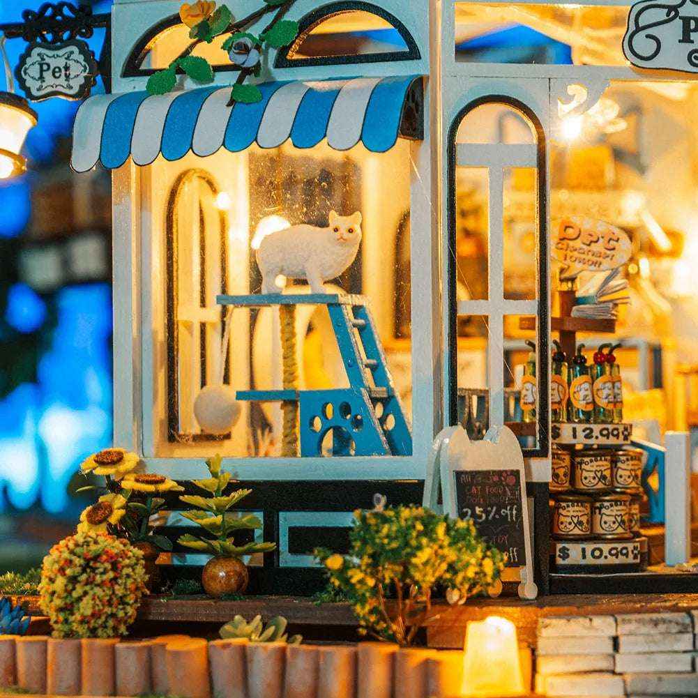 The Pet Club shop windows showing a white cat on a blue ladder and a miniature birdcage.
