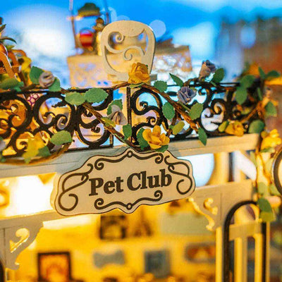 The Pet Club rooftop sign framed by decorative railings and trailing plants.
