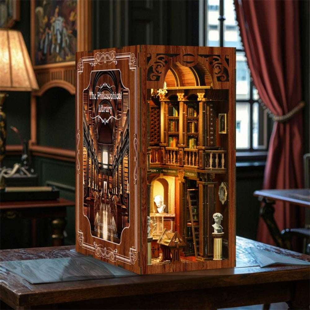 The Philosophical Library book nook with wood-toned panels and a tall illuminated library interior.