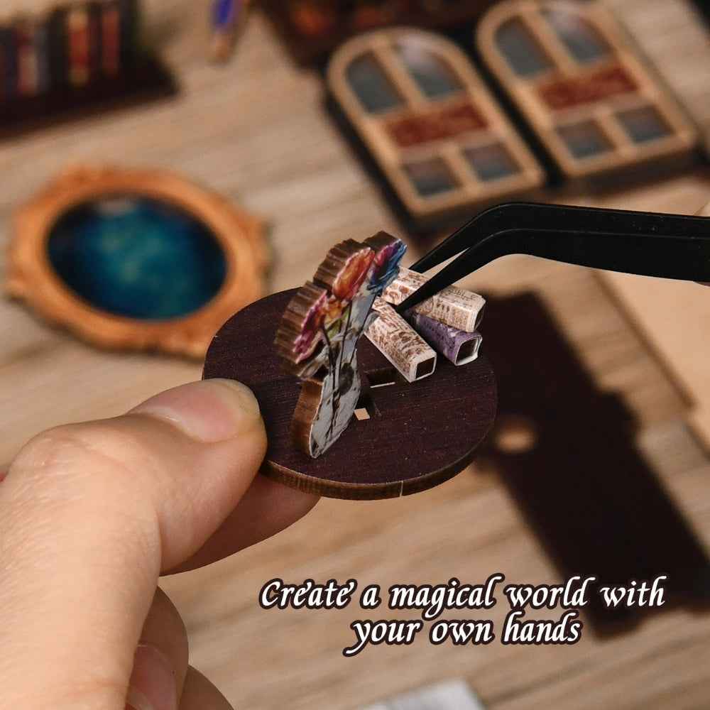 Tweezers placing a small component for The Realm of the Magic Book.