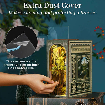 Hand removing the clear front cover from The Wizard of Oz book nook.