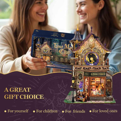 Two women holding a Time Magic Club kit box beside the assembled shop.