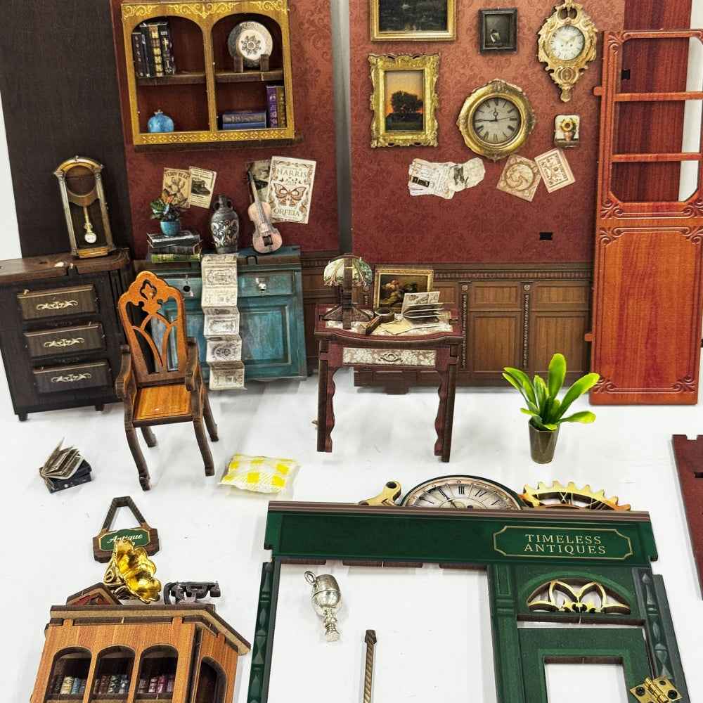 Timeless Antiques interior panels, miniature furniture and shopfront pieces laid out for assembly.