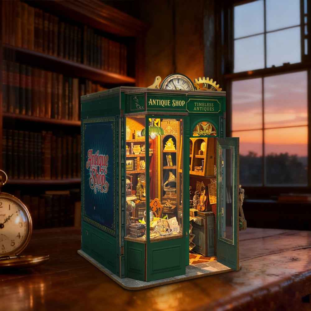 Timeless Antiques book nook on a desk with its green door open.