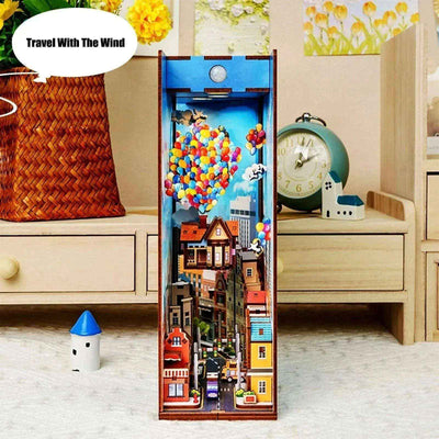 Travel with the Wind miniature town and balloon house displayed beside a clock and small figurine.